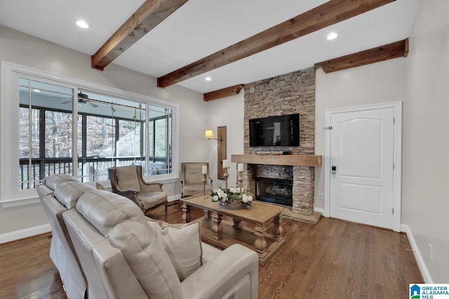 living area featuring baseboards, wood finished floors, a fireplace, beam ceiling, and recessed lighting