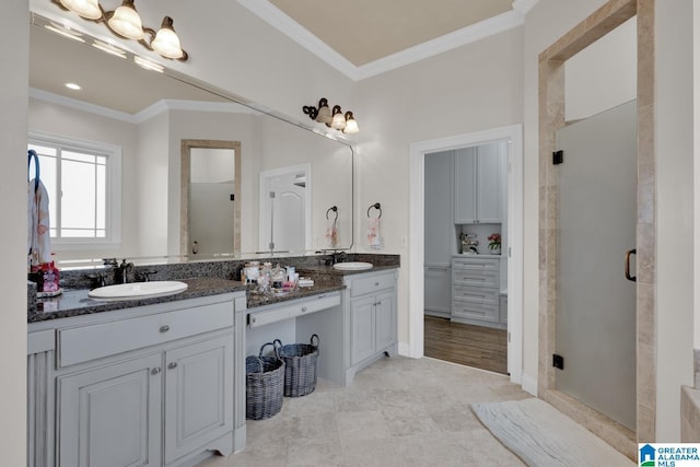 full bath with double vanity, a shower stall, ornamental molding, and a sink