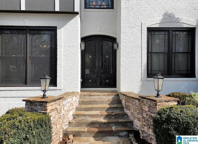 view of exterior entry with brick siding