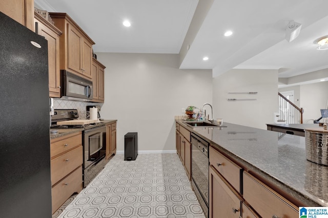 kitchen featuring black appliances, crown molding, decorative backsplash, and a sink