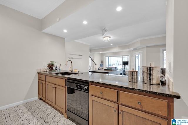 kitchen featuring baseboards, dishwasher, dark stone countertops, a peninsula, and a sink