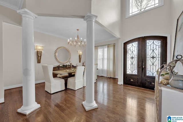 entrance foyer with french doors, wood finished floors, and decorative columns