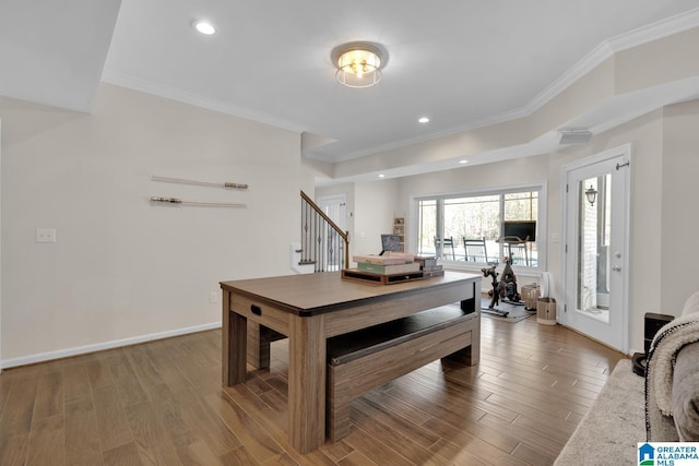 dining area with baseboards, ornamental molding, wood finished floors, stairs, and recessed lighting