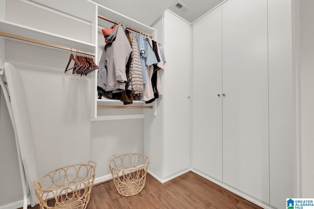 spacious closet with visible vents and wood finished floors