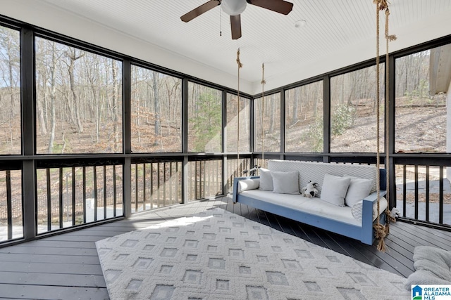 sunroom / solarium featuring a ceiling fan