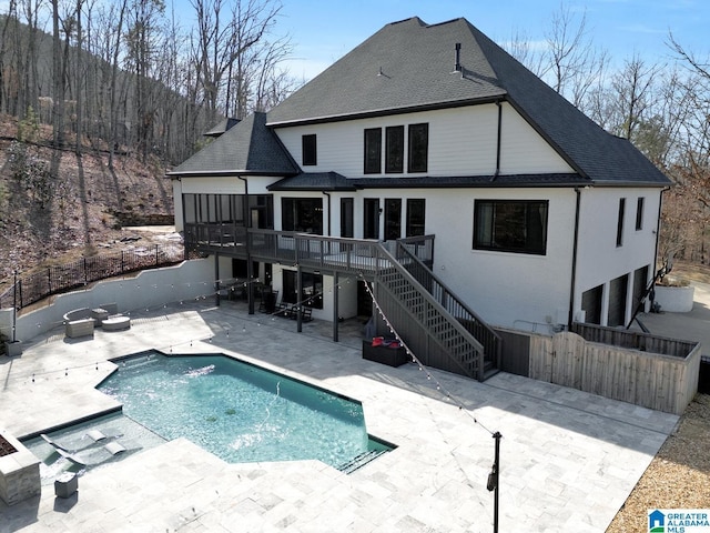 back of house with a deck, fence, stairs, roof with shingles, and a patio area