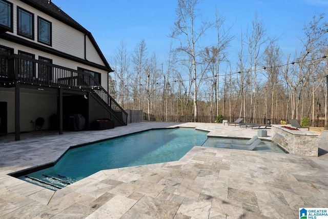 view of pool with a fenced backyard, stairway, a deck, and a patio