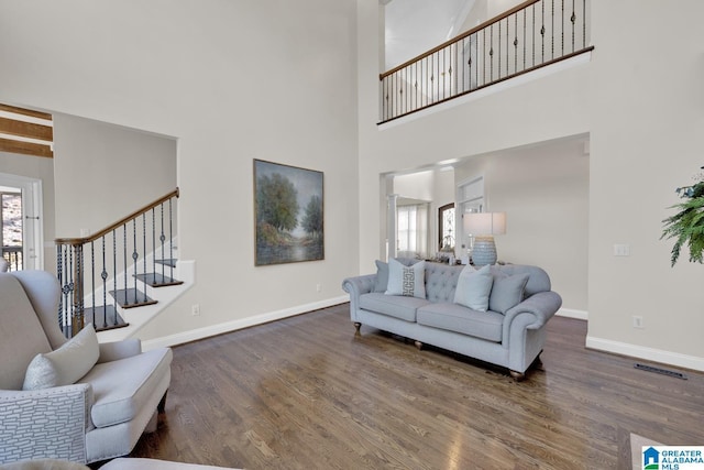 living room featuring a wealth of natural light, baseboards, and wood finished floors