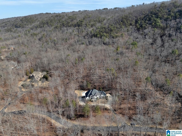 birds eye view of property featuring a wooded view