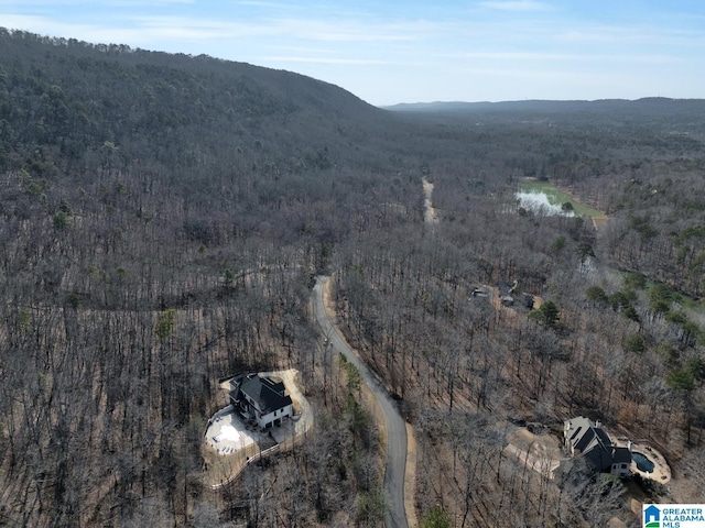 bird's eye view featuring a wooded view and a mountain view