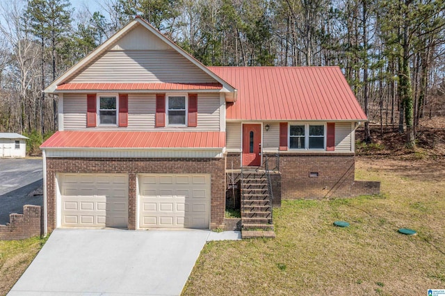 tri-level home with brick siding, concrete driveway, metal roof, crawl space, and a front yard