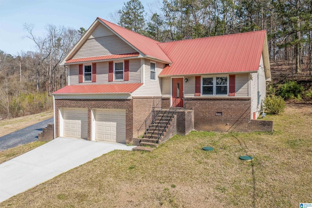 split level home with driveway, a front yard, metal roof, and brick siding