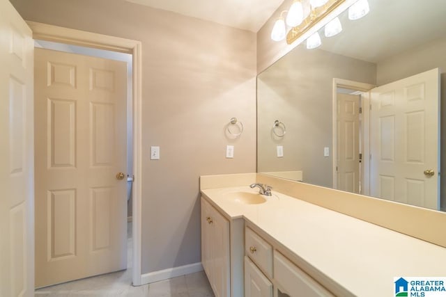 bathroom featuring tile patterned floors, vanity, and baseboards