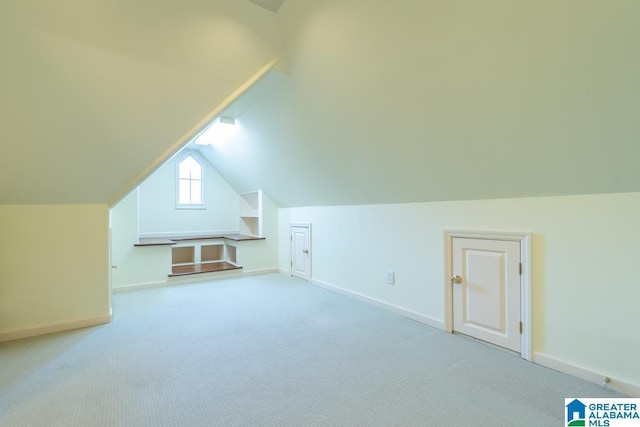 bonus room featuring lofted ceiling, carpet flooring, and baseboards