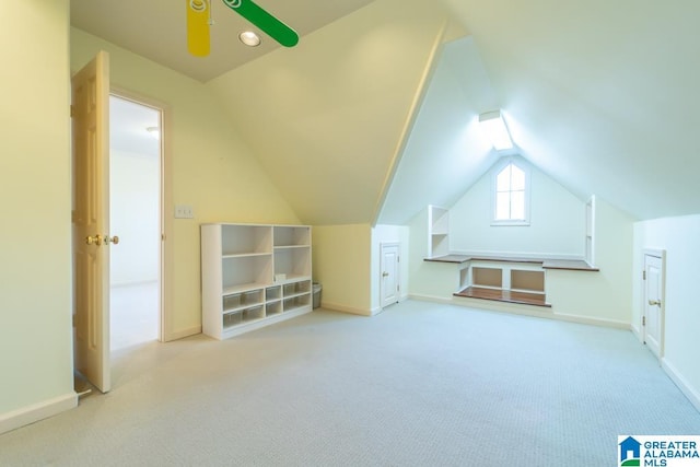 bonus room featuring lofted ceiling, carpet flooring, and baseboards