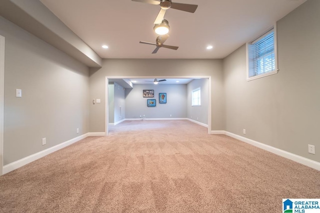 basement with carpet floors, baseboards, a ceiling fan, and recessed lighting