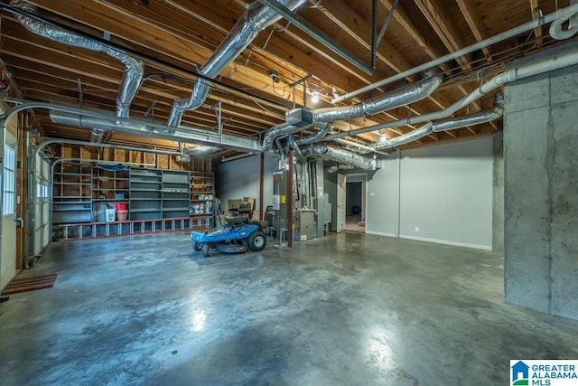 garage featuring water heater and heating unit