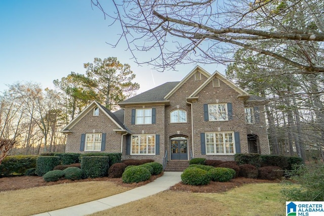 view of front facade with french doors and brick siding