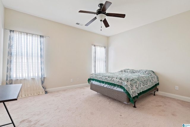 bedroom with a ceiling fan, baseboards, visible vents, and carpet floors