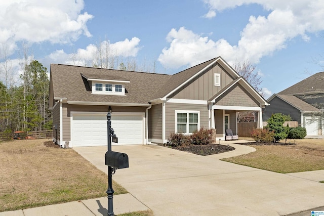 view of front of home with a front yard, fence, driveway, roof with shingles, and board and batten siding