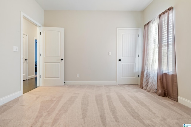 unfurnished bedroom featuring baseboards and carpet floors