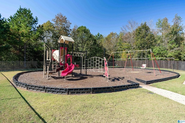 community play area with a yard and fence