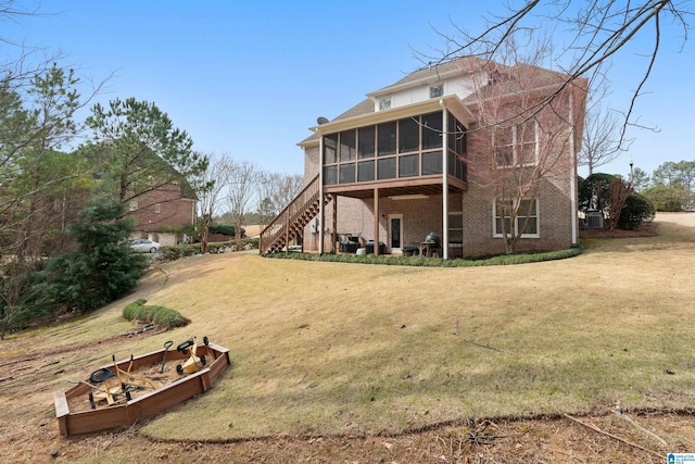 1401 Haddon Pl, Hoover, AL 35226 - rear view of house with a sunroom, a yard, brick siding, and stairway
