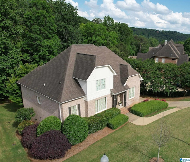 1401 Haddon Pl, Hoover, AL 35226 - view of front of house featuring a shingled roof, brick siding, a front yard, and a view of trees