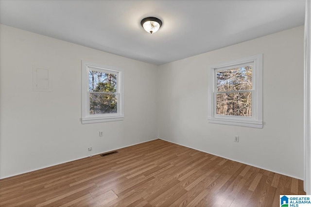 empty room featuring light wood-style flooring and visible vents