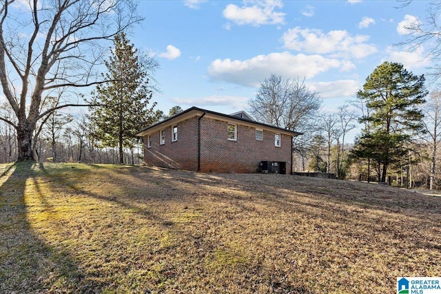 view of property exterior featuring a yard and brick siding