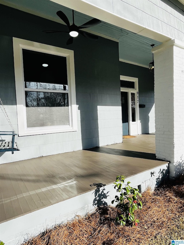 doorway to property featuring covered porch and ceiling fan