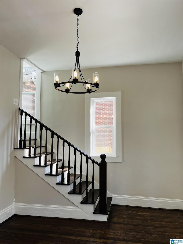 stairs with wood finished floors, a healthy amount of sunlight, and baseboards