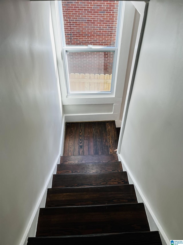 stairway featuring baseboards