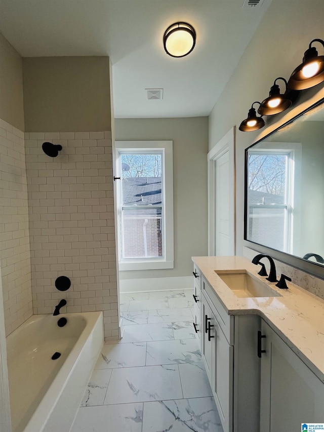 bathroom featuring visible vents, baseboards, shower / bathing tub combination, marble finish floor, and vanity