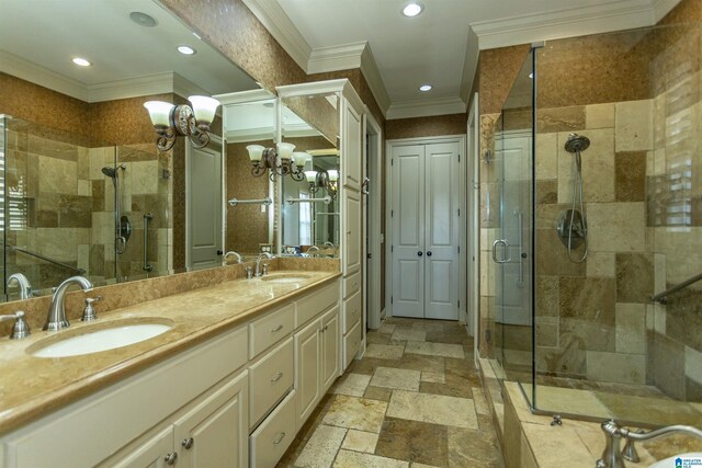 full bath with ornamental molding, stone tile flooring, a shower stall, a sink, and recessed lighting