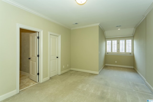 empty room featuring light carpet, baseboards, visible vents, and crown molding