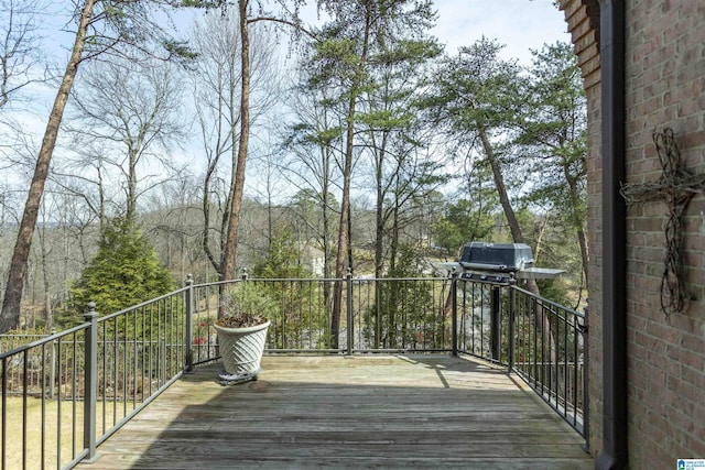 wooden terrace with a grill