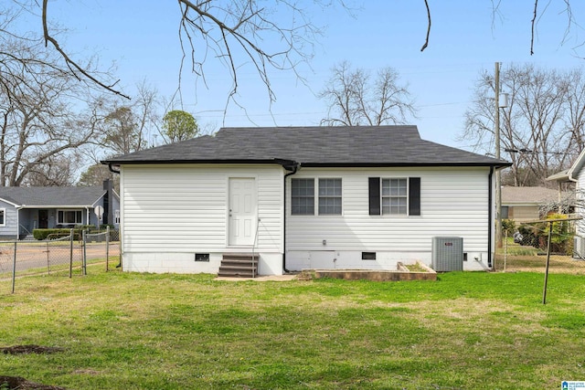 back of property with entry steps, crawl space, fence, cooling unit, and a yard