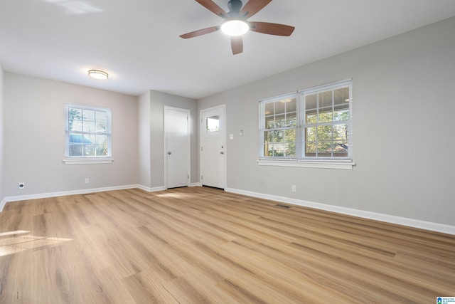 entrance foyer with light wood-type flooring, visible vents, ceiling fan, and baseboards