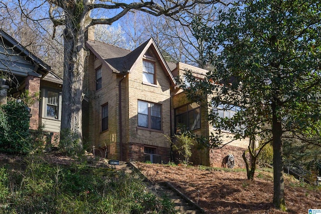 view of side of property featuring brick siding