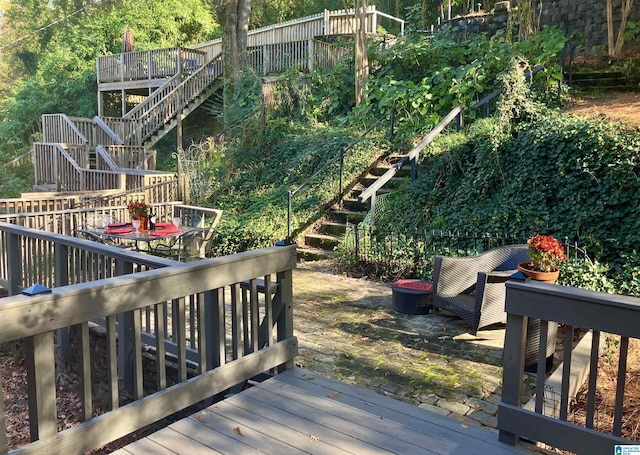 wooden deck featuring fence and stairway