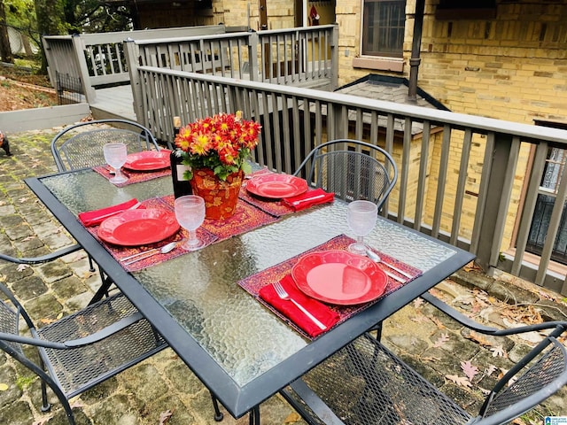 view of wooden balcony featuring a deck and outdoor dining space