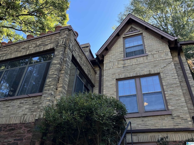 view of side of home featuring brick siding