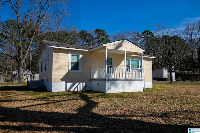 bungalow-style home featuring crawl space, a front lawn, a porch, and central AC