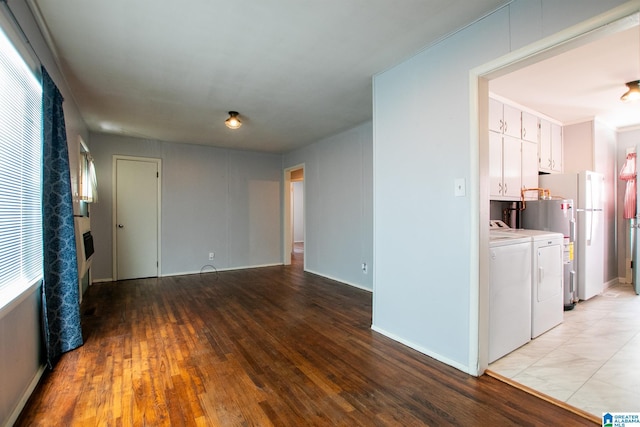 interior space featuring ornamental molding, independent washer and dryer, and light wood-style flooring