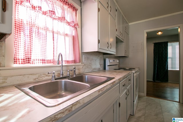 kitchen with white range with electric stovetop, crown molding, tasteful backsplash, light countertops, and a sink