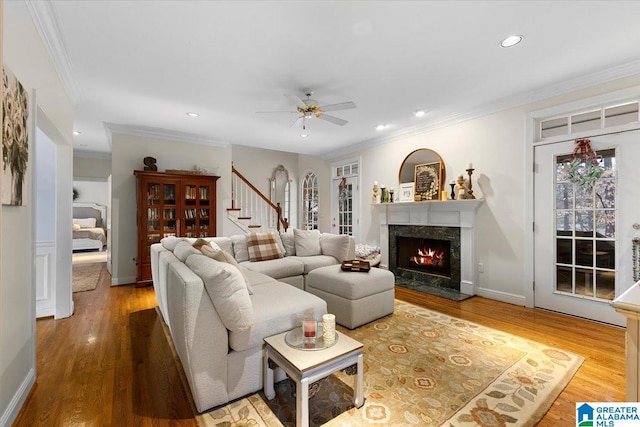 living room with crown molding, stairway, wood finished floors, and recessed lighting