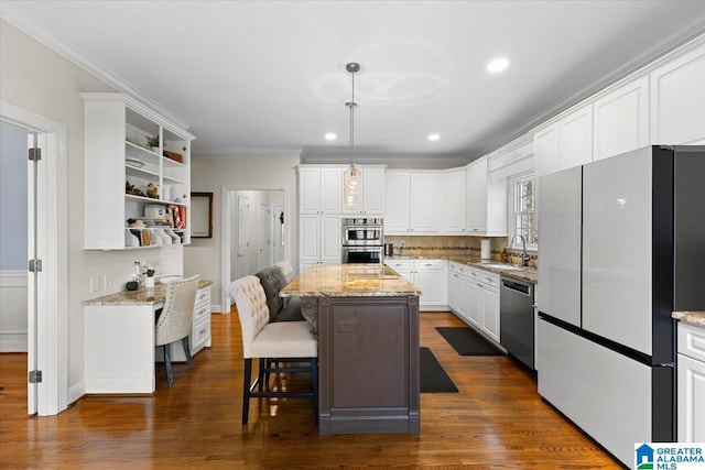 kitchen featuring stainless steel appliances, dark wood finished floors, white cabinets, and a sink