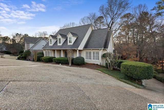 cape cod home with roof with shingles