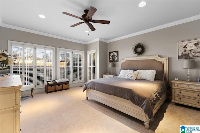 bedroom featuring multiple windows, crown molding, and light colored carpet